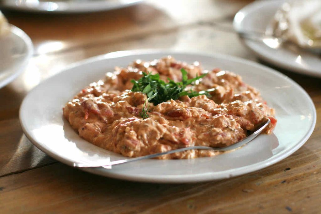 A white plate of htipiti, red pepper and feta dip as served at The Real Greek restaurant at Westfield Stratford, East London. 